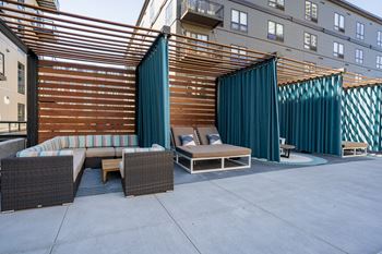 A patio with couches and tables in a courtyard